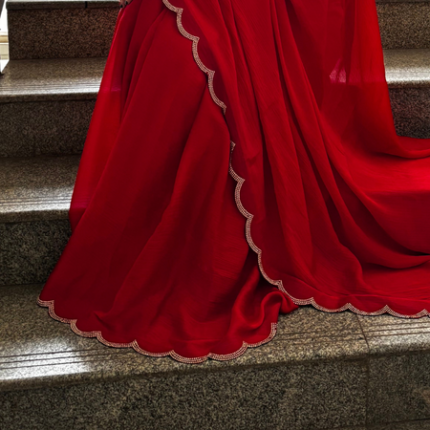 Shop red Georgette saree with beads, stones and silver scalloped border. Comes with an unstitched blouse piece, perfect for festive and party wear.